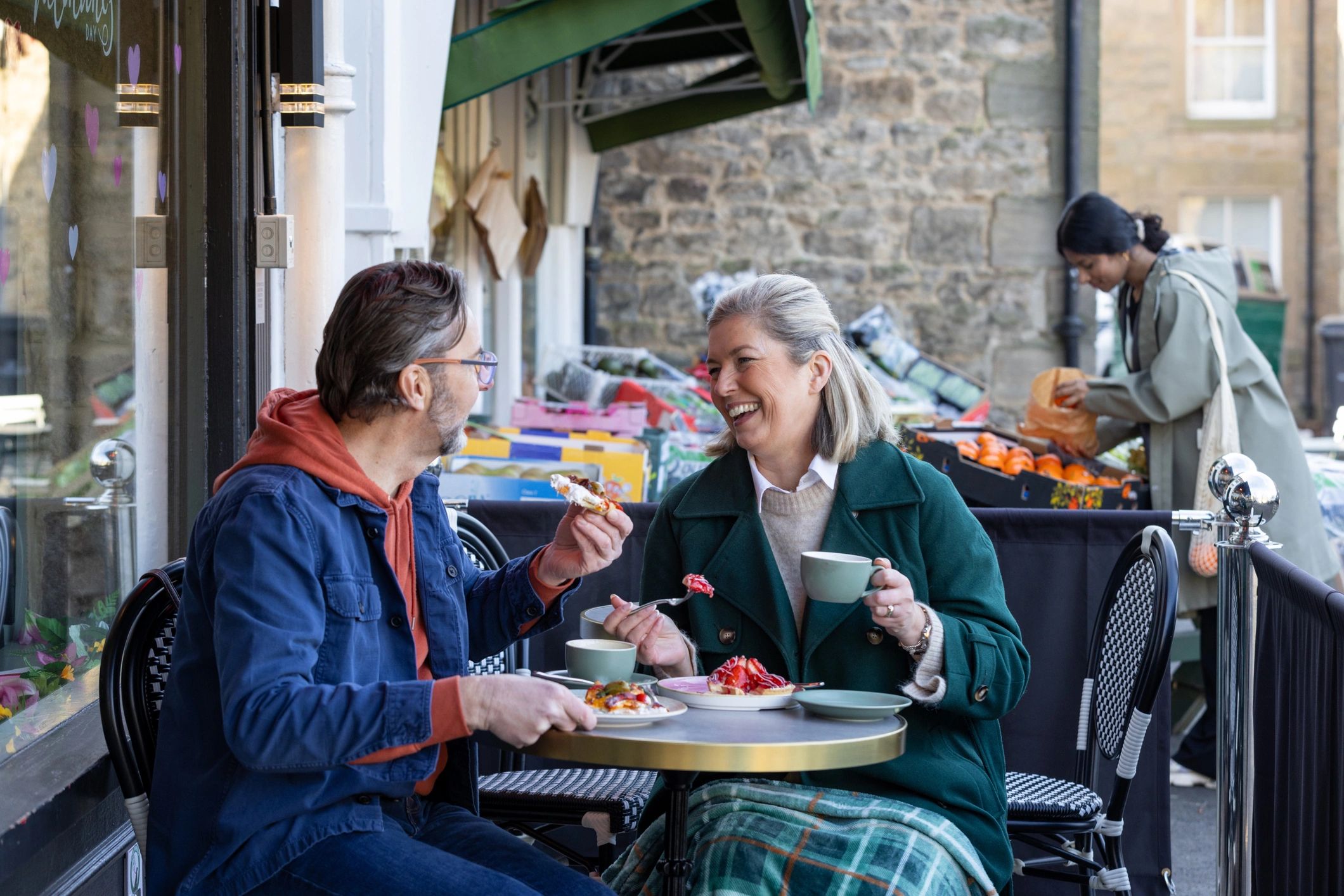 Two Friends Enjoying Food And Warm Conversation